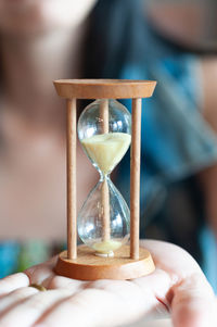 Close-up of person holding clock at home