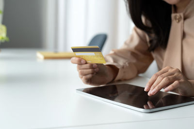 Midsection of woman using mobile phone