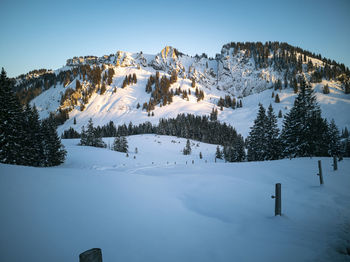 Scenic view of snow covered mountains against sky