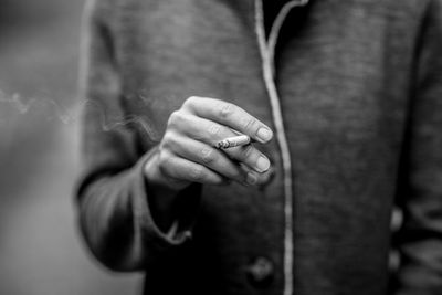 Close-up of woman holding cigarette