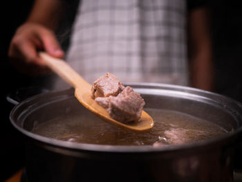 Close-up of hand holding meat