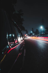 Light trails on road in city at night
