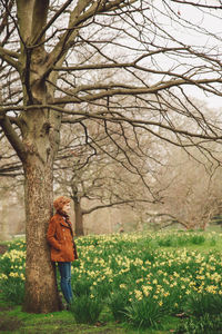 Woman standing by tree at park