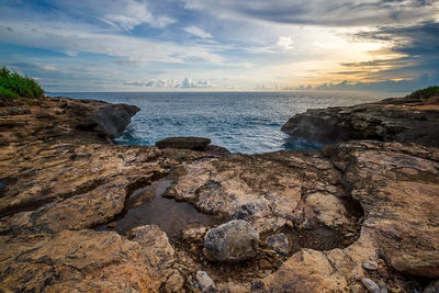 Scenic view of beach against sky during sunset