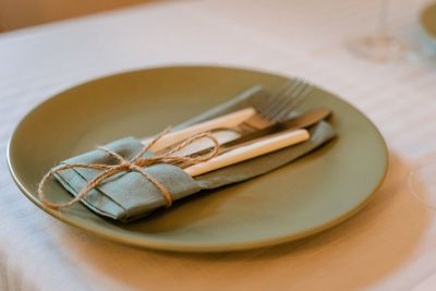 High angle view of cutlery with green napkin boho 