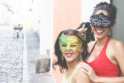 Portrait of two women wearing venice carnival mask. 