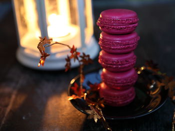 Close-up of illuminated lamp on table
