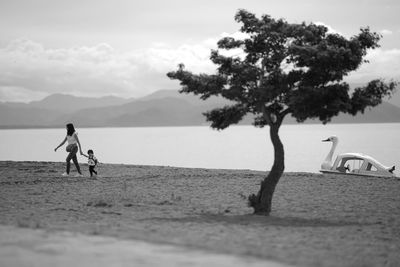 People on beach against sky