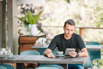 Man sitting on table in cafe