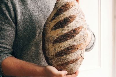 Close-up of man holding fresh baked bread