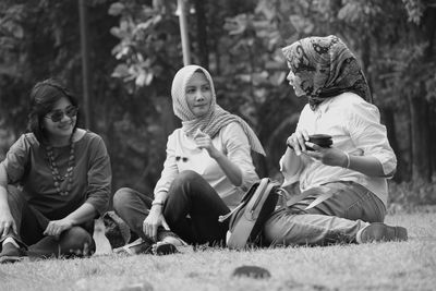 Three women sitting in park