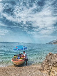 People on beach against sky