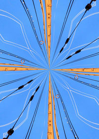 Low angle view of cables against blue sky