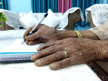 Close-up of woman holding hands on table