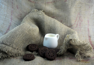 Close-up of cookies with milk on burlap