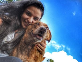 Close-up portrait of smiling young woman with dog