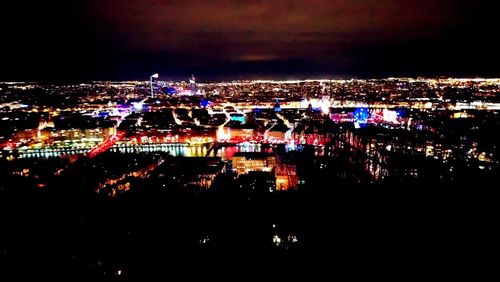 High angle view of illuminated city buildings at night