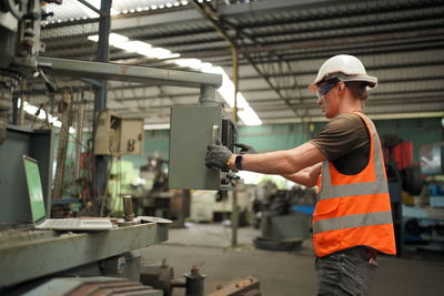 Industrial worker indoors in factory. man working in an industrial factory.