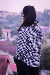 Rear view of woman standing against sky