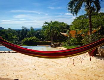 Hammock at poolside against sky