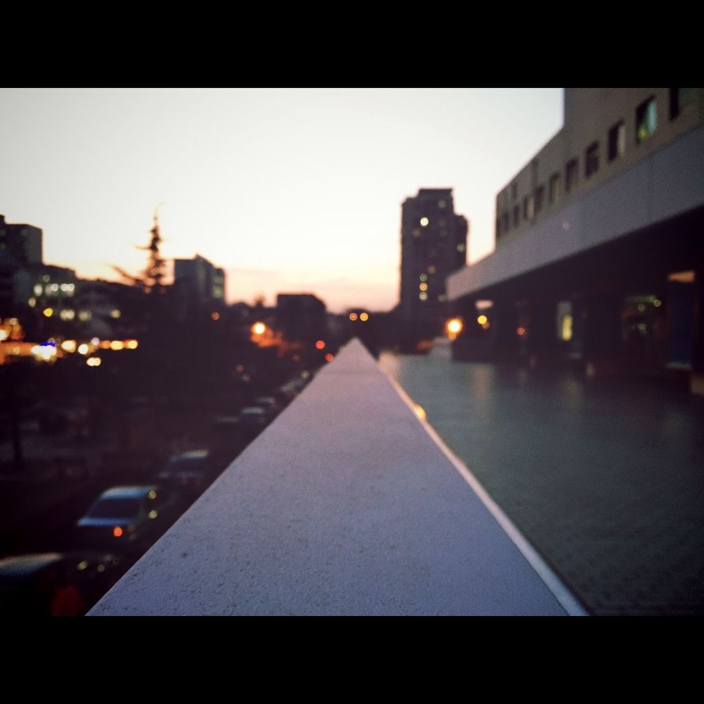 building exterior, architecture, city, built structure, illuminated, street, city street, night, transportation, road, city life, clear sky, transfer print, auto post production filter, dusk, car, sky, cityscape, the way forward, road marking