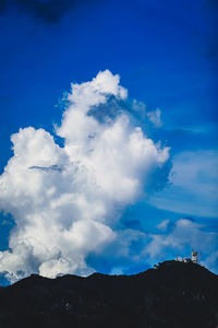 Low angle view of mountain against blue sky