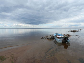 Boats moored on sea against sky