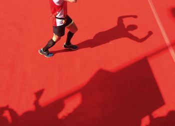 Low section of happy runner crossing finish line