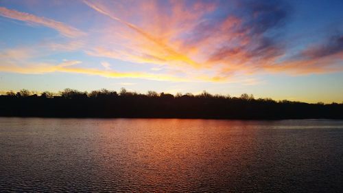 Scenic view of lake at sunset