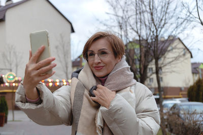 Portrait of young woman using mobile phone