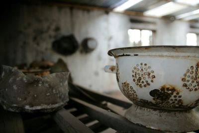 Close-up of old abandoned utensils on counter top