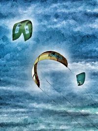 Low angle view of kite flying over sea against sky