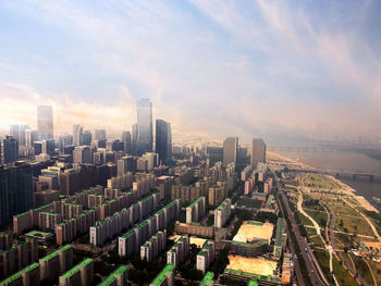 High angle view of city against cloudy sky