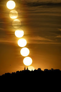 Silhouette trees against sky during sunset