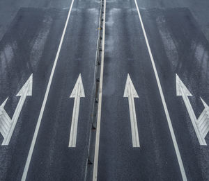 High angle view of arrow symbol on road in city