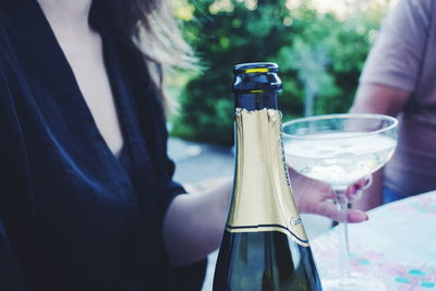 Midsection of woman holding drink