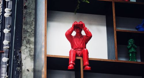 Statue of man looking through binoculars