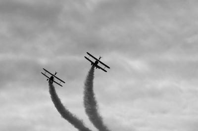 Low angle view of airplane flying against sky