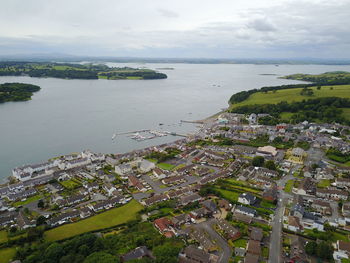 High angle view of town by sea against sky