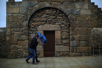 Couple walking in front of old building