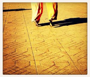 Low section of woman standing on tiled floor