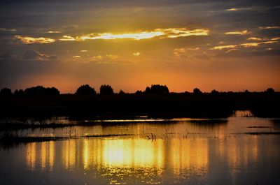 Scenic view of lake against orange sky