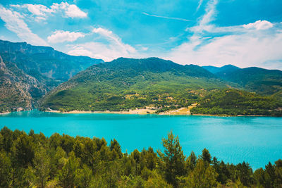 Scenic view of lake and mountains against sky