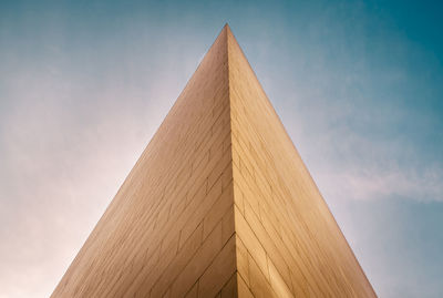 Low angle view of building against cloudy sky