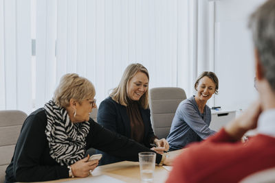 Smiling women talking during business meeting