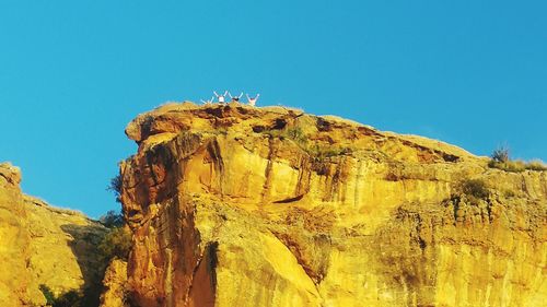 Low angle view of rock formations against sky