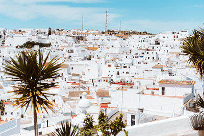 White village against blue sky with yucca trees in southern spain