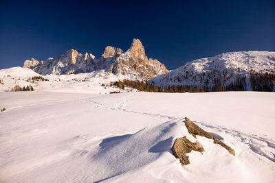 Scenic view of snow covered mountains against clear sky