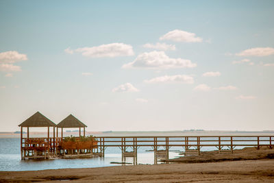 Lifeguard hut on beach against sky