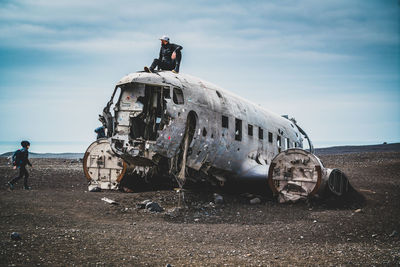 View of abandoned airplane on airport runway against sky